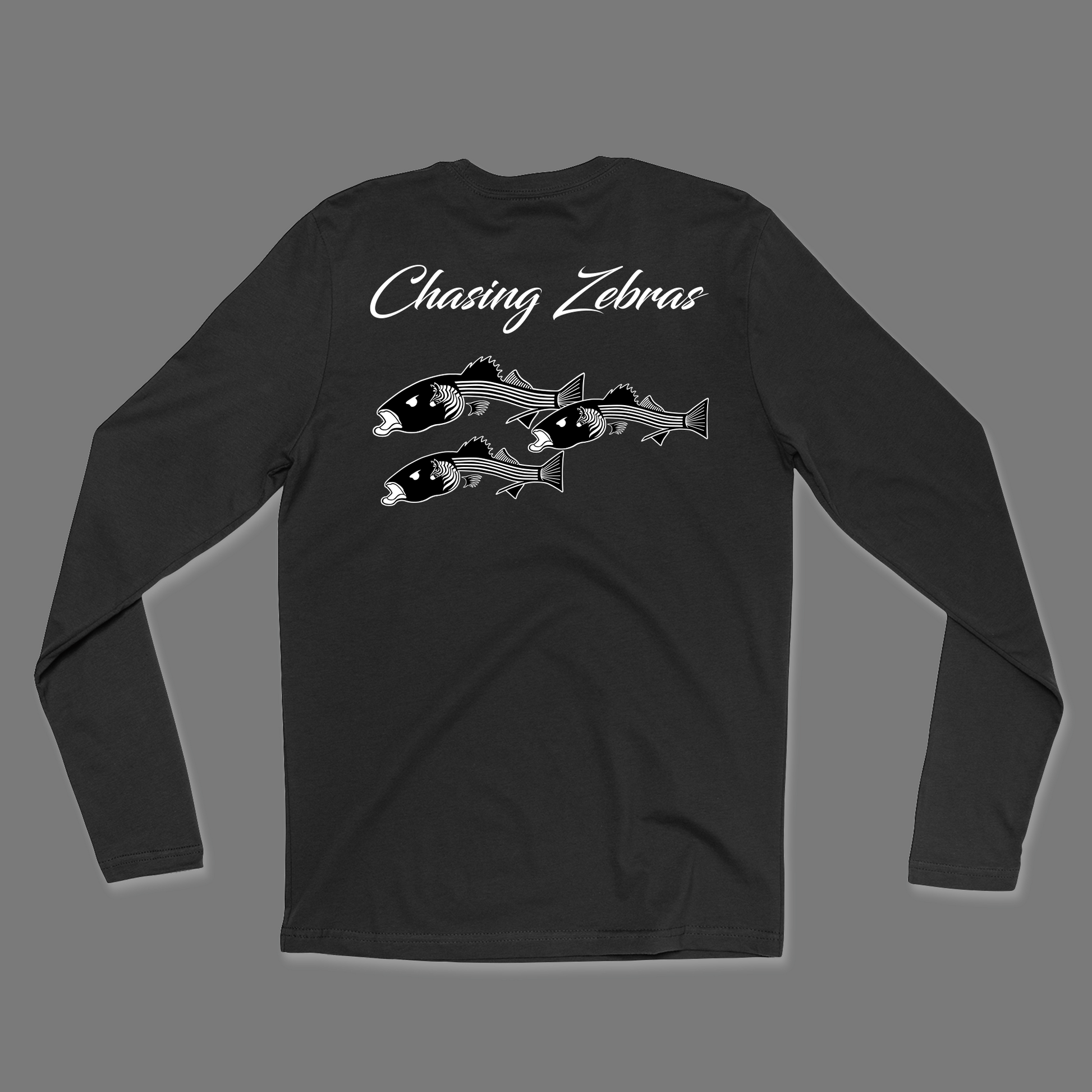 Back of a black long sleeve shirt. It says Chasing Zebras across the back and under it has a design of 3 striped bass in black and white and the striped bass have zebras on the side of their head