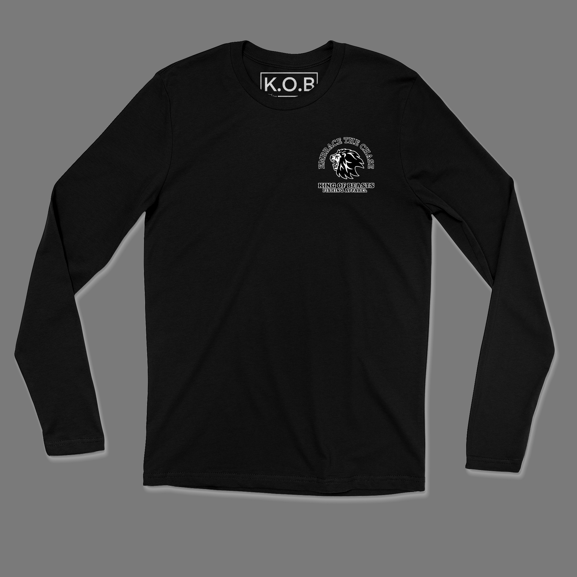 Front of a black long sleeve shirt. On the left side of the chest it has a lion roaring and around the lion it says embrace the chase King Of Beasts Fishing Apparel. Neck tag says K.O.B Fishing Apparel