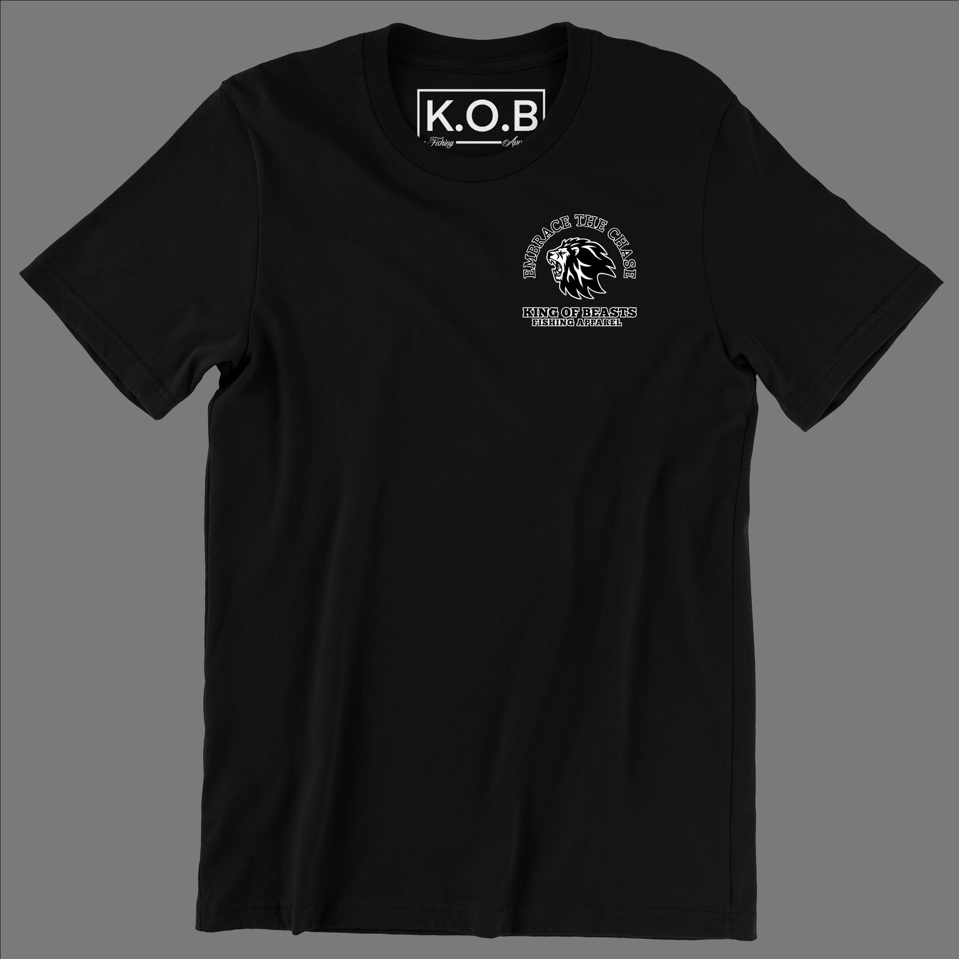 Front of a black t shirt. On the left side of the chest it has a lion roaring and around the lion it says embrace the chase King Of Beasts Fishing Apparel. Neck tag says K.O.B Fishing Apparel